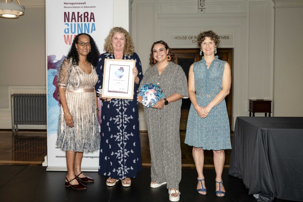 Representatives from the winning early learning service, Evans Head-Woodburn Preschool, accepting their trophy and certificate at the Narragunnawali Awards ceremony.